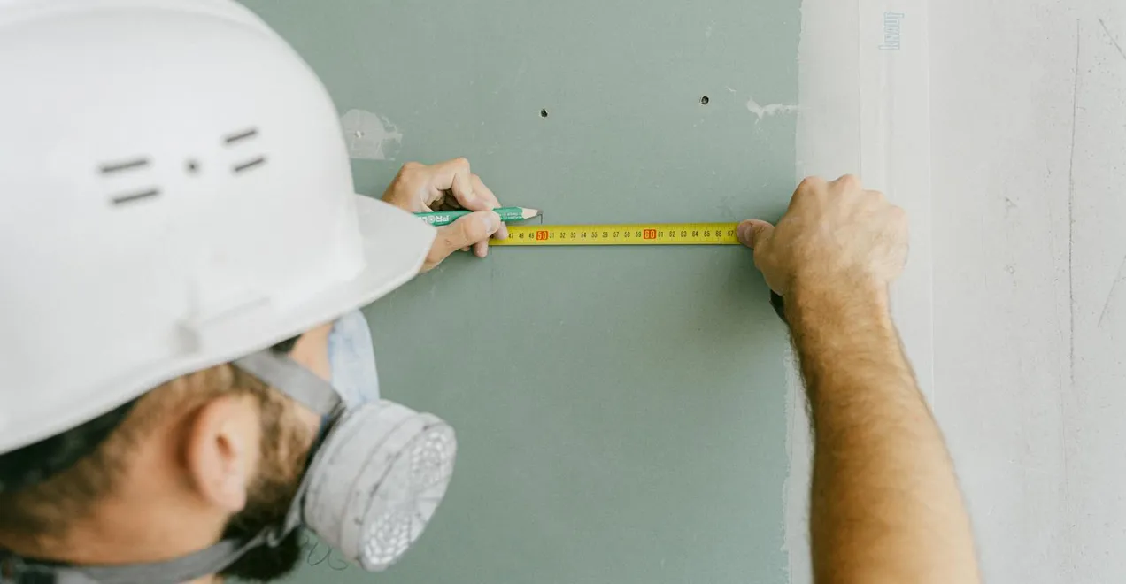 Measuring a space during an on-site walkthrough.