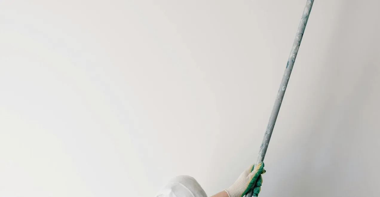 Rolling a final finish coat across a freshly prepared surface.