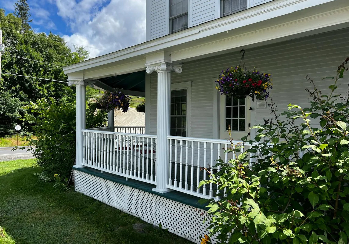 A freshly repaired and painted front porch, warm and inviting.